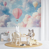 Hot air balloon wall mural in a baby's room with gentle lighting