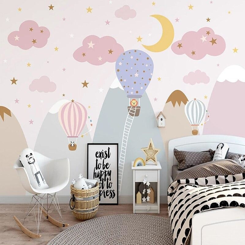 Hot air balloon wallpaper bringing whimsy to a playroom with soft pink and gold accents
