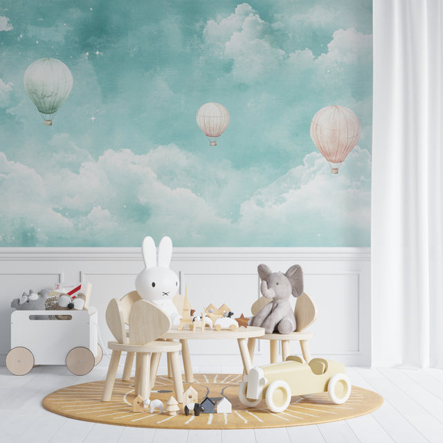 Hot air balloon wallpaper creating a magical atmosphere in a modern nursery with soft pink accents