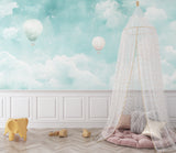 Hot air balloon wall mural creating depth in a cozy reading nook with natural lighting