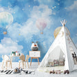 Hot air balloon wallpaper creating a dreamy atmosphere in a bright nursery with white furniture