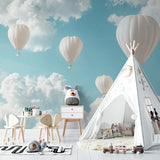 Sky mural with floating balloons bringing light and air to a children's bedroom