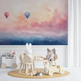 Hot air balloon wallpaper creating a magical atmosphere in a bright nursery with soft pink accents