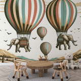 Hot air balloon wallpaper with flying elephants creating a magical atmosphere in a bright nursery with reading nook