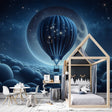Hot air balloon wallpaper creating a dreamy atmosphere in a modern nursery with soft lighting and star details