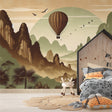 Hot air balloon wallpaper creating a cozy atmosphere in a modern living room with natural light and mountain views