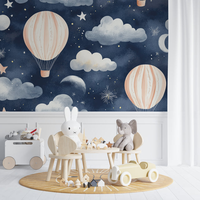 Hot air balloon wallpaper in a cozy nursery with soft lighting showing pink balloons against starry night sky