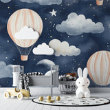 Night sky wallpaper with hot air balloons transforming a baby's bedroom