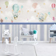 Hot air balloon nursery wallpaper creating a magical atmosphere in a bright, modern nursery with white furniture