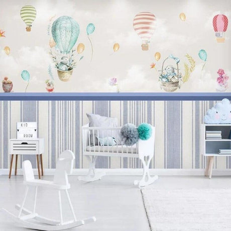 Hot air balloon nursery wallpaper creating a magical atmosphere in a bright, modern nursery with white furniture