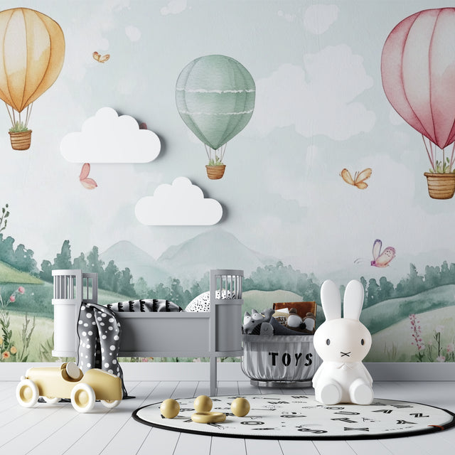 Hot air balloon nursery wallpaper creating a dreamy atmosphere in a modern white nursery with natural wood furniture