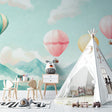 Hot air balloon nursery wallpaper creating a dreamy atmosphere in a modern white nursery with wooden furniture
