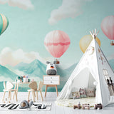 Hot air balloon nursery wallpaper creating a dreamy atmosphere in a modern white nursery with wooden furniture