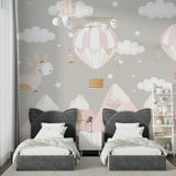 Children's room featuring pink hot air balloon mural with reading nook