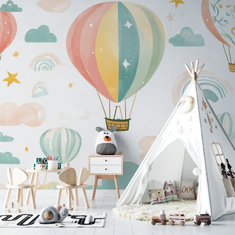 Hot air balloon nursery wallpaper in a bright modern nursery with white furniture