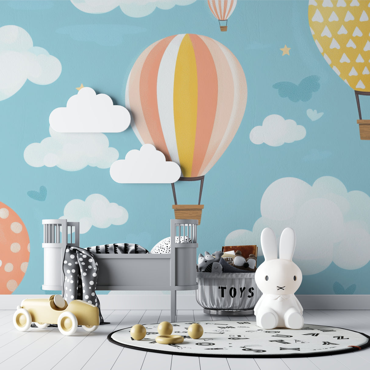 Hot air balloon wallpaper in a bright nursery with white furniture, showing floating pastel balloons against a gentle blue sky
