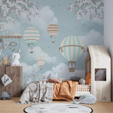 Pastel hot air balloon wallpaper brightening a girl's bedroom with natural light