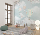 Cherry blossom balloon mural creating depth in a playroom with modern furniture