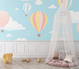 Kids bedroom featuring hot air balloon wallpaper with soft clouds and stars, perfect for bedtime stories