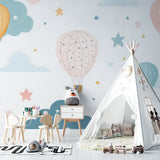 Kids bedroom featuring hot air balloon mural wallpaper, reading nook with floating shelves and plush toys