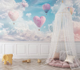 Pink heart balloon mural creating depth in a kids playroom with reading nook