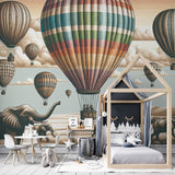 Hot air balloon safari wallpaper creating a magical atmosphere in a bright nursery with gentle elephant silhouettes below