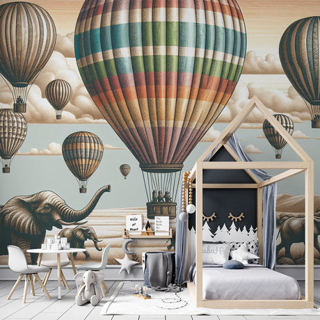 Hot air balloon safari wallpaper creating a magical atmosphere in a bright nursery with gentle elephant silhouettes below