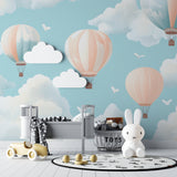 Hot air balloon nursery wallpaper in a modern white nursery, creating a soft and dreamy atmosphere
