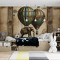 Hot air balloon wallpaper transforms a cozy nursery with vintage-inspired design and whimsical elephant motif