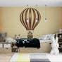 Hot air balloon wallpaper in a bright nursery, brown and cream vintage design creating a cozy storytelling corner