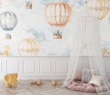 Watercolor balloon mural creating a dreamy atmosphere in a kid's reading nook