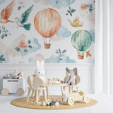 Hot air balloon nursery wallpaper creating a magical atmosphere in a cozy white nursery with rocking chair