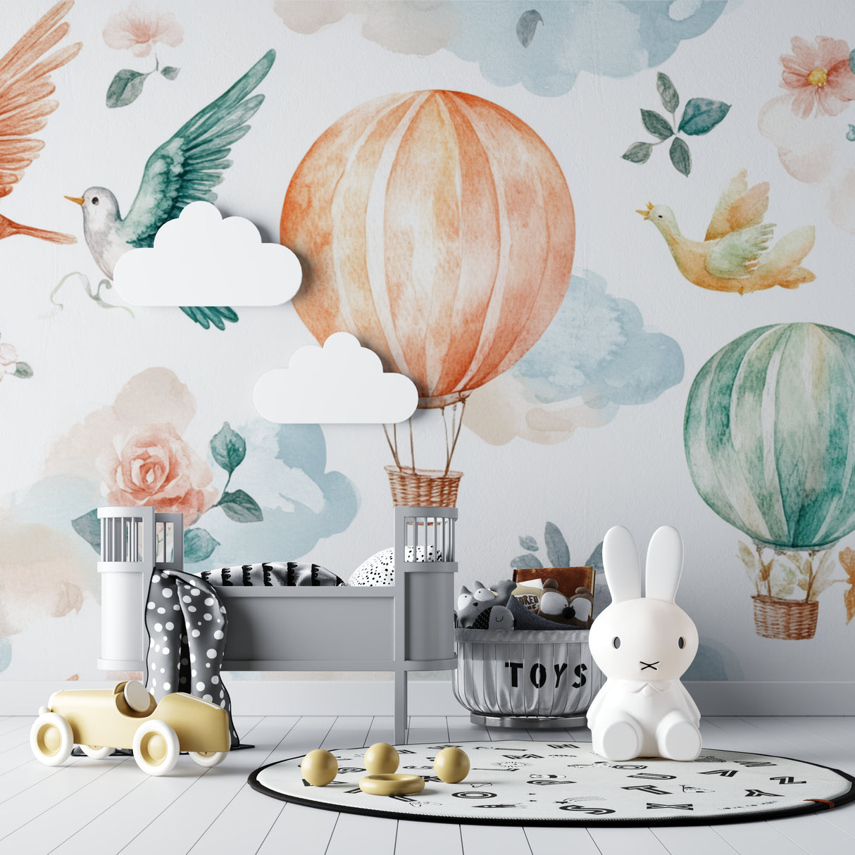 Hot air balloon mural adding whimsy to a baby girl's nursery