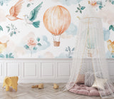 Balloon and bird wallpaper creating a sweet reading nook in kids room