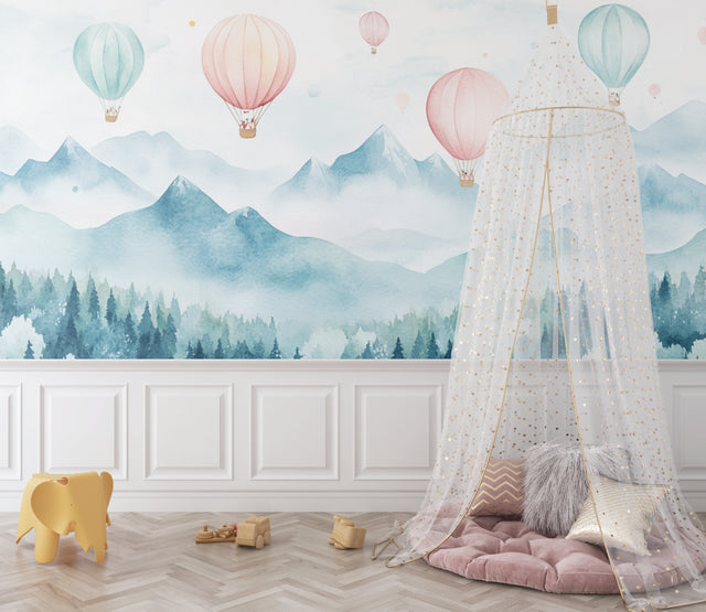 Hot air balloon wallpaper in a bright nursery, pink and mint balloons floating above misty mountains