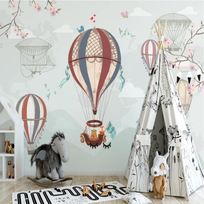 Whimsical hot air balloon wallpaper brightening a neutral nursery with wooden accents