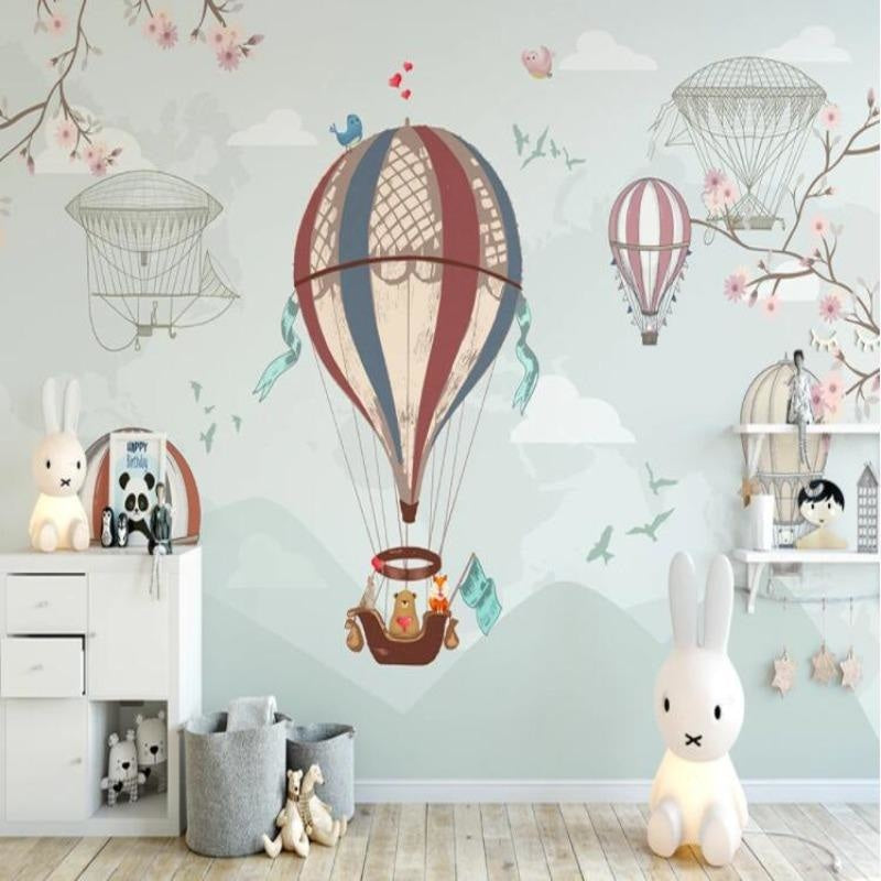 Nursery wall mural with floating balloons complementing a modern baby room setup