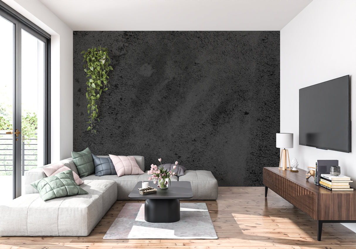 Black concrete effect wallpaper in modern living room creates industrial atmosphere with dark furniture