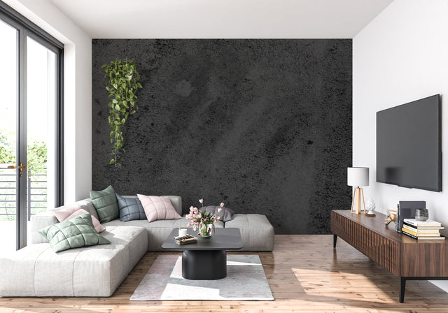 Black concrete effect wallpaper in modern living room creates industrial atmosphere with dark furniture