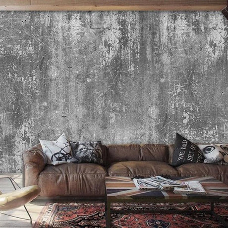 Industrial concrete effect wallpaper in modern minimalist living room with grey sofa and metal accents