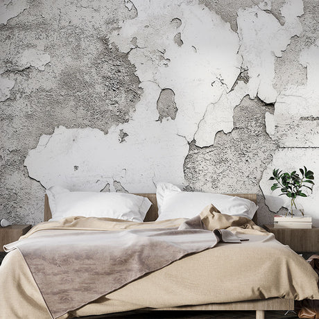 Industrial concrete effect wallpaper in a modern minimalist living room showing textured gray tones and natural shadows