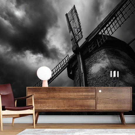 Black and white industrial windmill wallpaper creating dramatic impact in a modern office space with minimal furniture