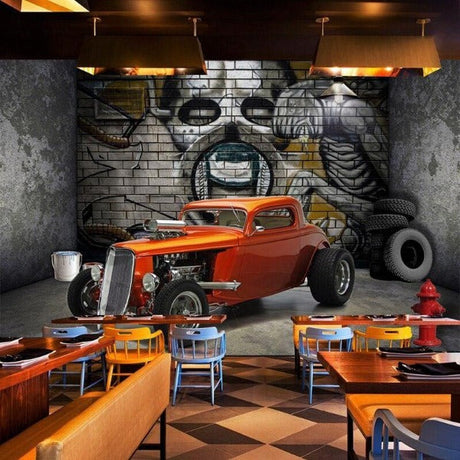 Industrial hot rod wallpaper creating urban atmosphere in modern living room with grey sofa and metal accents