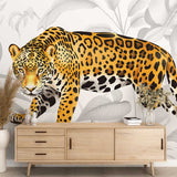 Jaguar wallpaper mural creating a bold statement in a modern living room, golden wild cat against gray monstera leaves