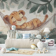 Baby lion wallpaper mural shown in a cozy nursery with soft lighting and natural wood furniture