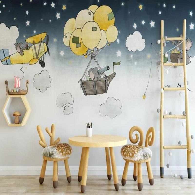 Kids bedroom featuring elephant and stars wallpaper with modern white furniture