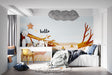 Forest wallpaper creating a cozy reading nook in a modern kids bedroom with natural light and wooden furniture