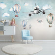 Aviation wallpaper bringing life to a bright nursery with hot air balloons and airplanes floating above the crib