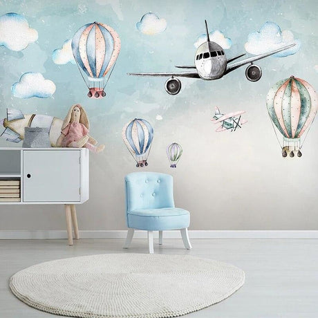 Aviation wallpaper bringing life to a bright nursery with hot air balloons and airplanes floating above the crib