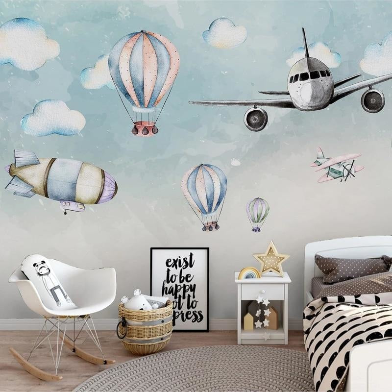 Kids bedroom transformed with airplane and hot air balloon wallpaper, creating a playful atmosphere